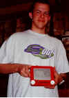 Kyle Coates with his Etch-A-Sketch of foreign money at Barr Camp on Pike's Peak.